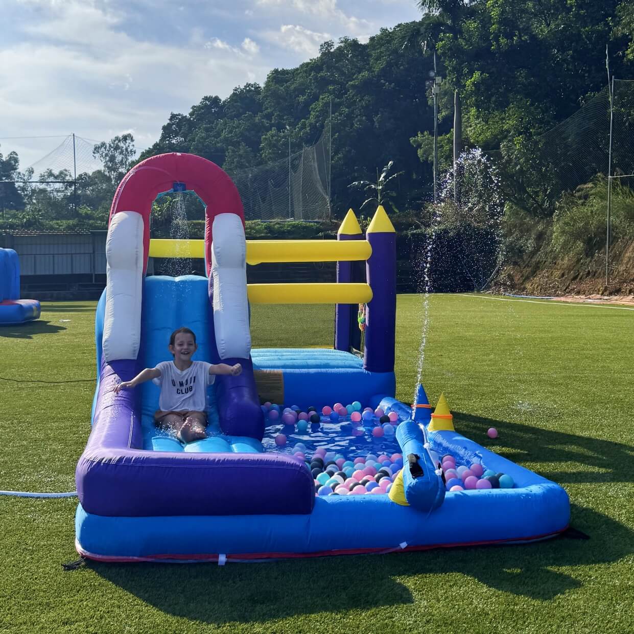 Bouncinlife Inflatable water slide with pool and ball pit on grassy area