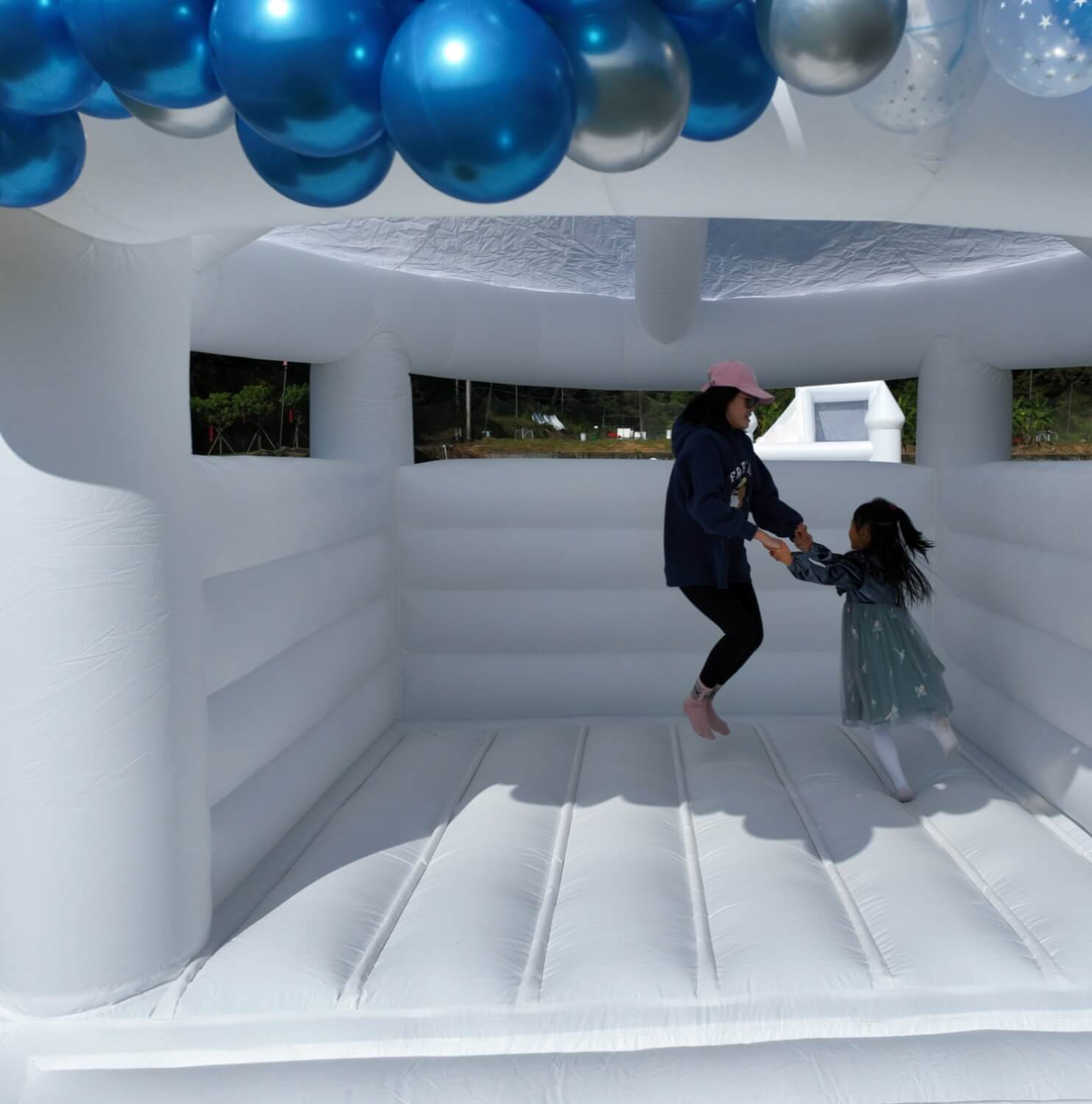 white bouncy house with roof