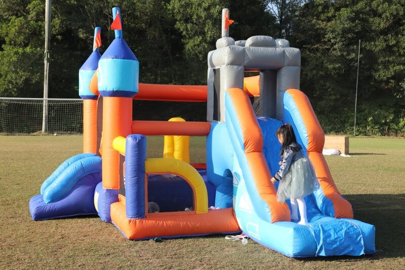 Colorful inflatable playground structure with a slide |bouncinlife